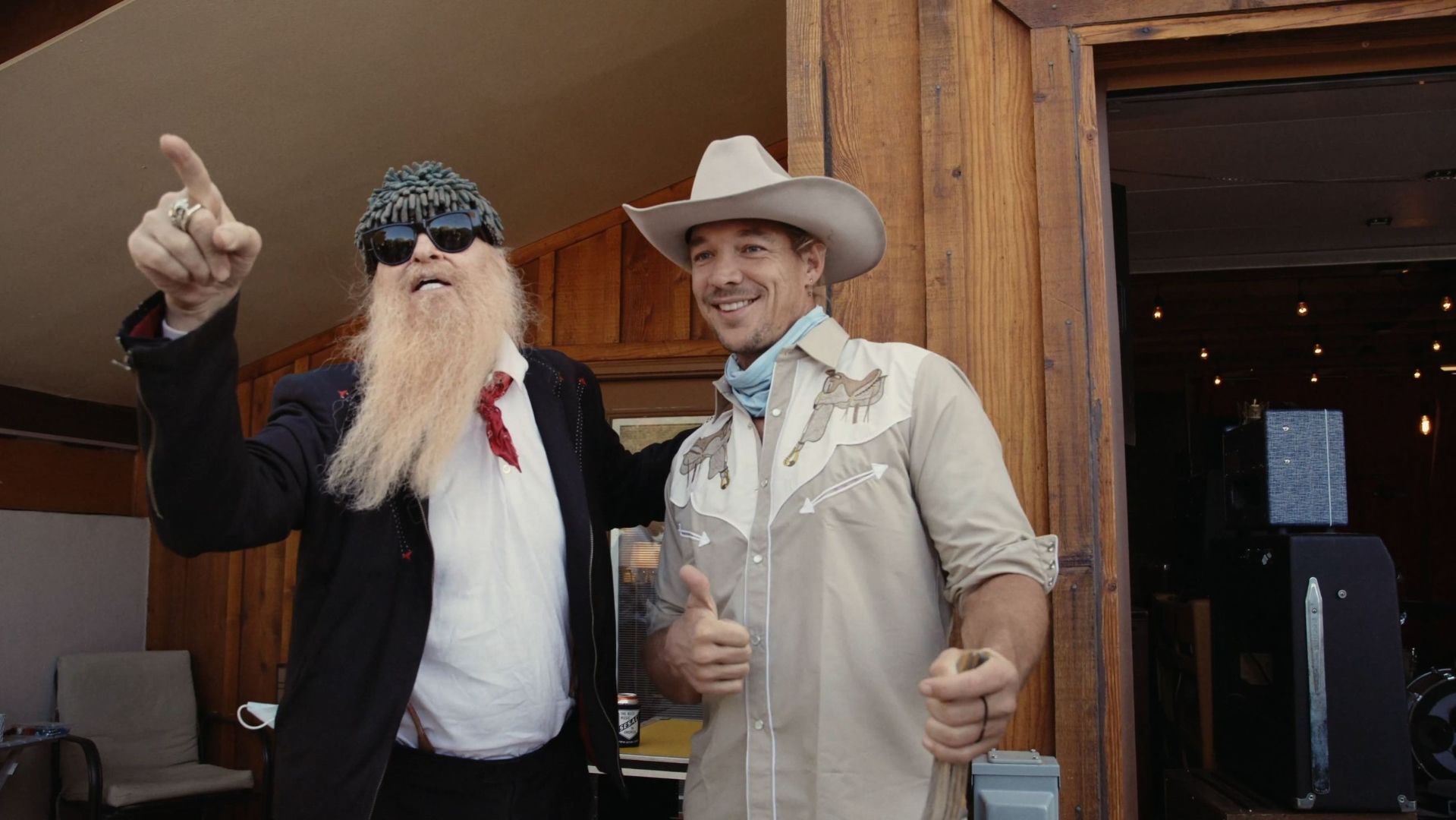 Billy Gibbons and Diplo together on the porch at ESCAPE — cowboy hats, wood and warm light, an unlikely pairing only the desert makes possible