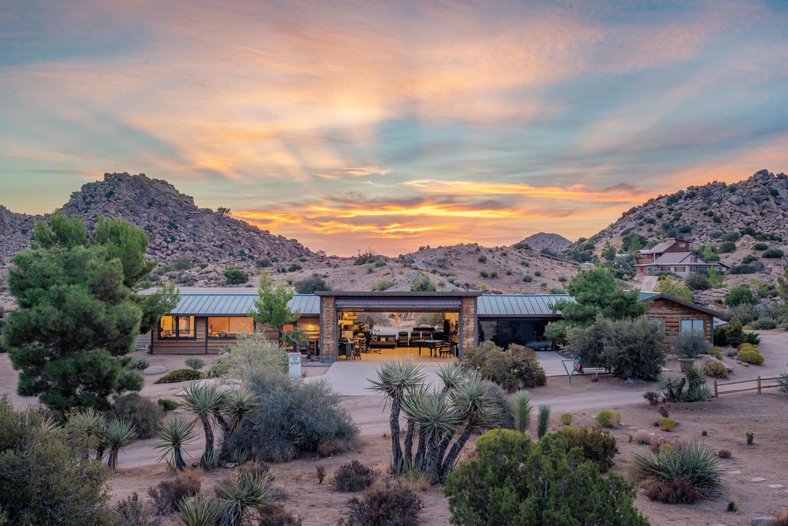 ESCAPE at sunset — the studios open to the desert, mountains beyond, golden hour over 140 acres in Pioneertown, California