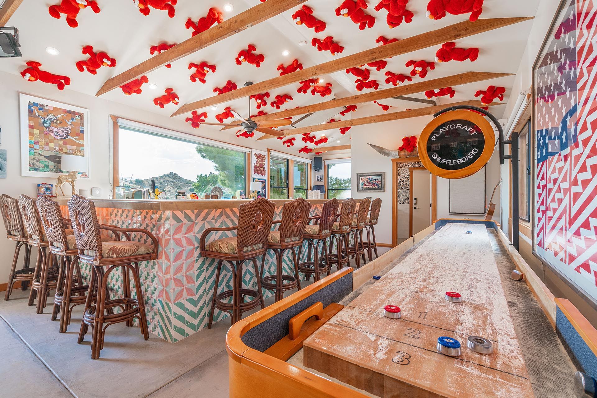 Shuffleboard and the bar at The Goat, ESCAPE — Playcraft shuffleboard, wicker bar stools, ceiling Elmos