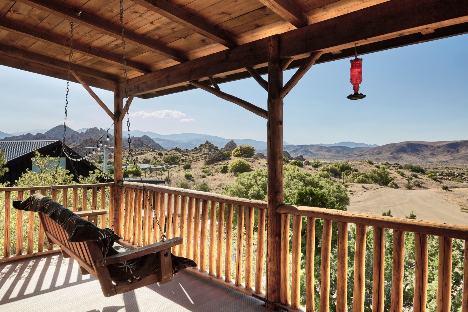 The Residence porch swing at ESCAPE looking across the property to the Pioneertown mountains