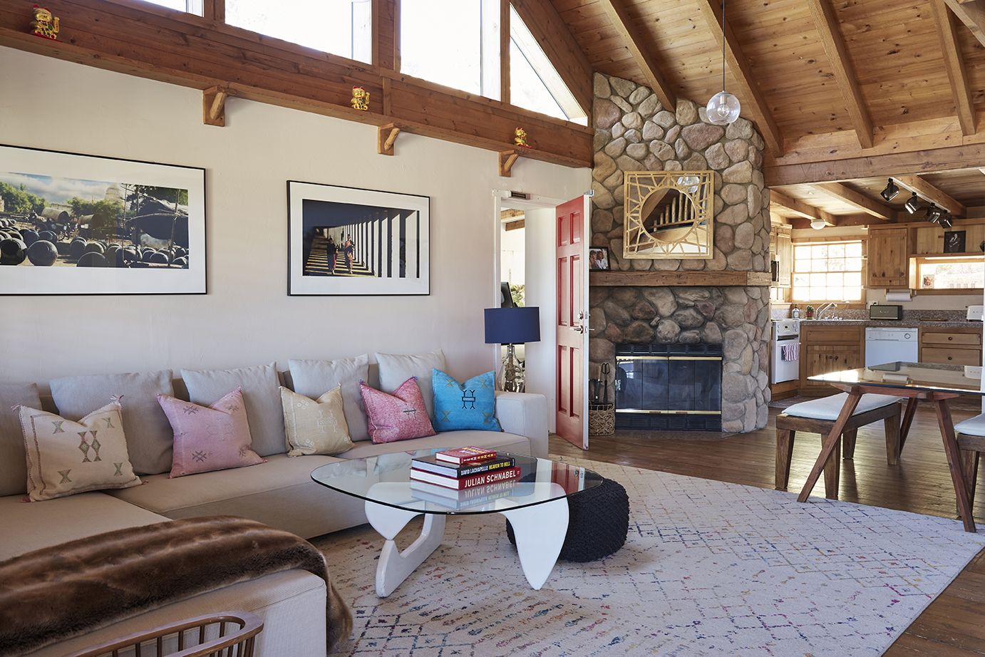 The Residence living room with cathedral ceiling and stone fireplace