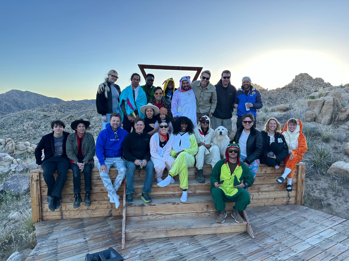 A camp group gathered at The Triangle in matching onesies at ESCAPE