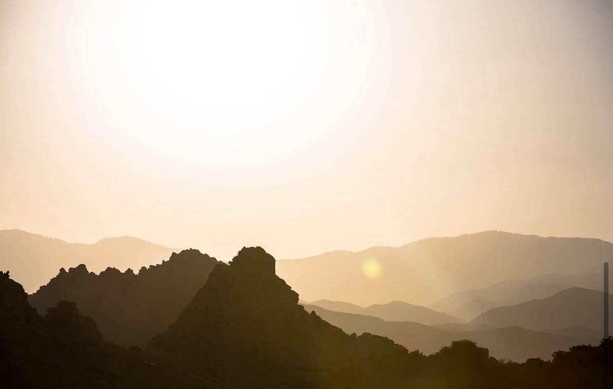 The sun setting behind the mountains over the high desert at ESCAPE