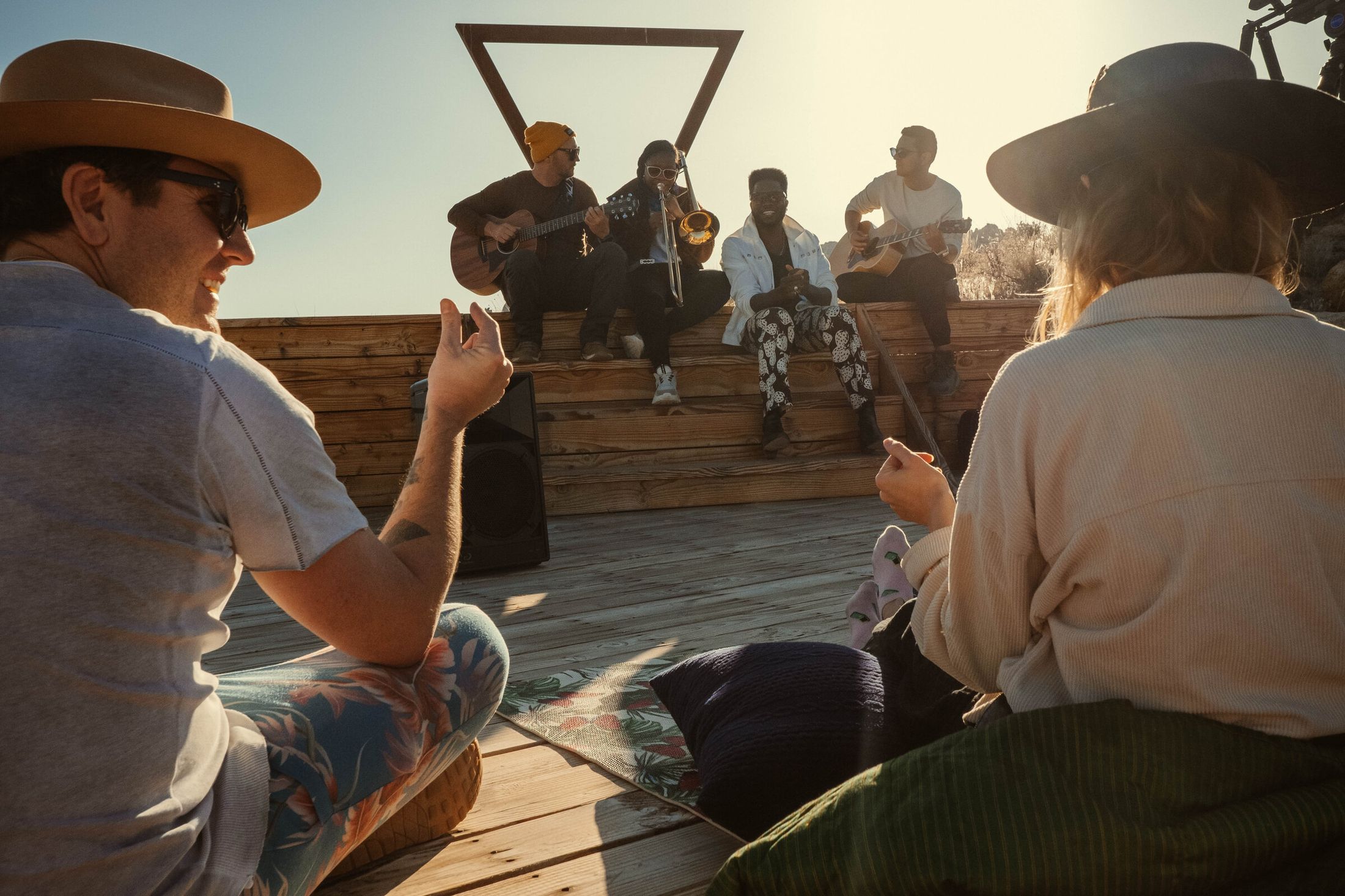Cimafunk performing live at The Triangle at ESCAPE — a desert stage on a ridge with mountains beyond